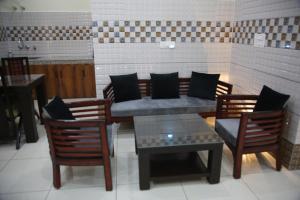 a restaurant with a table and chairs and a bench at Luxury Room with 1 Double Bed in Haridwār