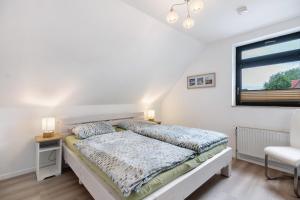 a bedroom with a bed and a window at Fewo Strandmuschel in Dangast +19 photos