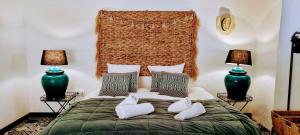 a bedroom with a bed with two towels on it at La parenthèse Thuir in Thuir +23 photos