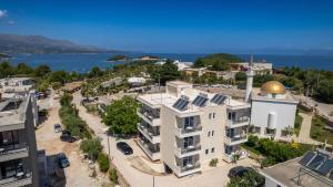 an apartment building with a gold dome on top of it at Golden Hotel in Ksamil