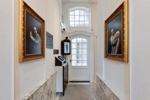 a hallway with two pictures on the walls and a door at The Sixteen in Amsterdam