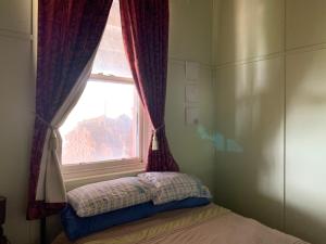 a window in a bedroom with a bed in front of it at Lockhart Railway Hotel in Lockhart