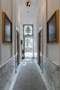 a hallway with two pictures on the walls of a building at The Sixteen in Amsterdam