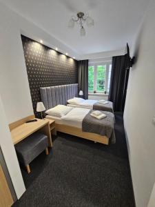 Posteľ alebo postele v izbe v ubytovaní Apartamenty N 25 Przy Kaponierze