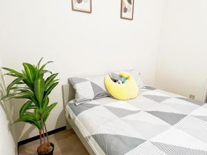 una camera da letto con un letto con un cuscino giallo sopra di 池袋電車2分3Room 6人可 a Tokyo