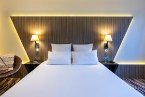 Uma cama ou camas num quarto em Nemea Appart Hotel Concorde Toulouse Gare Matabiau