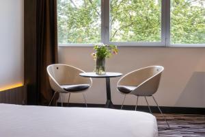 Uma cama ou camas num quarto em Nemea Appart Hotel Concorde Toulouse Gare Matabiau