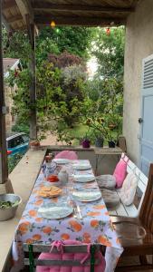 a table with plates of food on a patio at Les Jardins d'Ayaël in Ozenay +18 photos