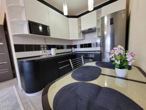 a kitchen with a table with purple flowers on it at 2 комн Апартаменты в ЖК Жемчужина 2 in Kokshetau +10 photos