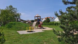 a childrens playground with a slide and a slideintend at Haus Piroschka in Mörbisch am See