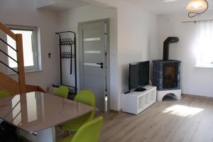 a living room with a dining table and a fireplace at Bałtyckie domki Kopalino in Kopalino