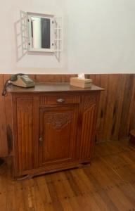 a wooden cabinet with a phone on top of it at Au coeur de Tana, vue sur le Palais de la Reine, en securité in Antananarivo