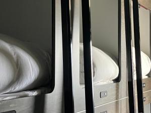 Postel nebo postele na pokoji v ubytování Capsule Hotel Suzumoriya