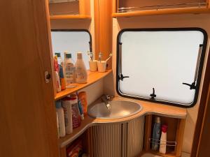 a bathroom with a sink and a sink at Dębki przyczepa kempingowa Fendt in Dębki
