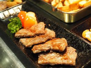 a tray of food with meat and vegetables on it at Dormy Inn Premium Osaka Kitahama in Osaka