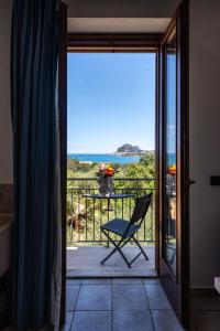 krzesło na balkonie z widokiem na ocean w obiekcie Hotel Baia Del Capitano w Cefalù