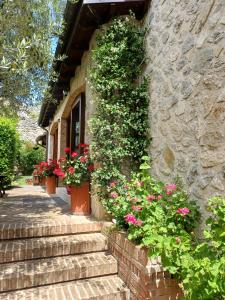 a building with flowers on the side of it at Agriturismo San GIovanni Ad Insulam in Isola del Gran Sasso dʼItalia