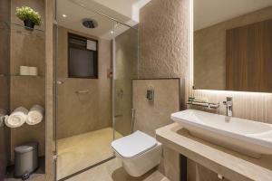 a bathroom with a sink and a toilet and a shower at Bella Vista Mahabaleshwar in Mahabaleshwar