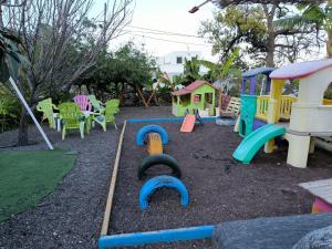 a playground with colorful play equipment in a yard at Hotel Rural La Raya 1866 in Güimar