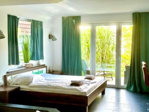 a bedroom with a bed and a window with green curtains at Seaside-Townhouse in Timmendorfer Strand