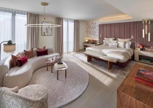 a bedroom with a bed and a living room at Mandarin Oriental Mayfair, London in London