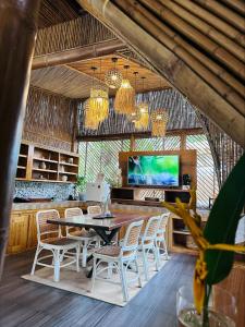 a dining room with a table and chairs at Alina Farm Resort- Two Bedroom Villa in Manolo Fortich