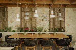 a dining room with a wooden table and chairs at Opal Paros in Naousa