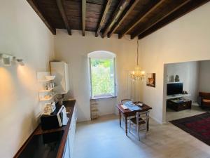 a living room with a table and a window at Chez Amèlie in La Spezia