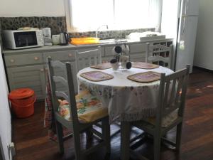 a table in a kitchen with a table and chairs at L’oiseau du Paradis in Nosy Be