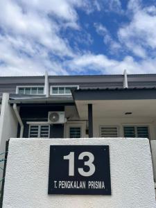 a house with a sign in front of it at Arai HOMESTAY in Pusing
