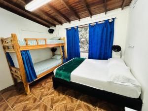 a bedroom with two bunk beds and a window at Blue Coast Hostal in Medellín