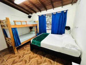 a bedroom with two bunk beds and a window at Blue Coast Hostal in Medellín