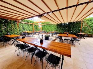 a group of tables and chairs under an umbrella at Къща за гости Карел in Nesebar
