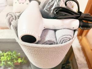 a basket filled with towels and a hair dryer at 高田馬場4分 4人可 203 in Tokyo