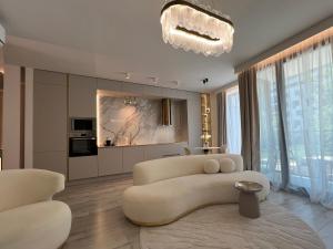 a living room with a couch and a table at Harmony Property WIN HERASTRAU in Bucharest