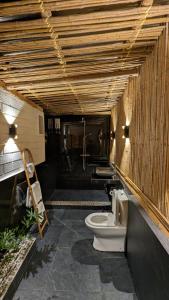 a bathroom with a toilet in a room at Alina Farm Resort- Two Bedroom Villa in Manolo Fortich