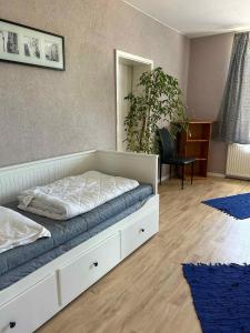a bedroom with a bed and a desk with a plant at Apartment Dierhagen - Ostseebad 4 in Dändorf +4 photos