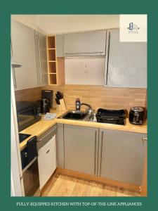 a small kitchen with a sink and a stove at Ideal for Professional Staff in LS1 Financial Hub in Leeds