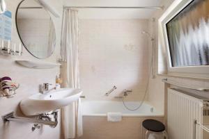 a bathroom with a sink and a shower and a tub at Abendrot in Münsingen +22 photos