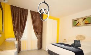 a bedroom with a bed and a chandelier at Gold Twins Boutique Hotel in Alanya