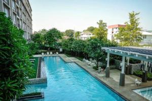 a swimming pool in the middle of a building at 350 METER BEACH, Newly renovated Condo in Hua Hin