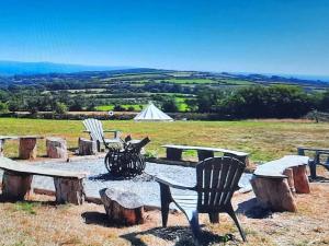 a group of park benches and a table and benches at Summit Camping Kit Hill Rd Cornwall Panoramic Views Grass Pitch from 15pn or Bella Bell Tent 75pn in Callington