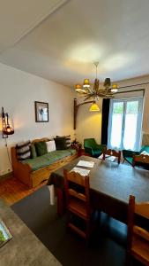 a living room with a bed and a table and a couch at Les Montagnettes in Le Mont-Dore