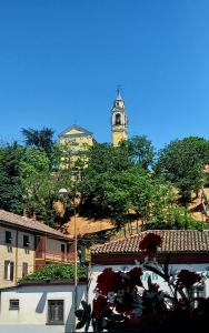 a building with a clock tower in the background at B&B La casa del mugnaio di Capriata d'Orba in Predosa