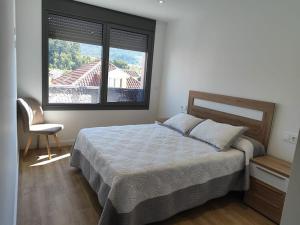 Ένα ή περισσότερα κρεβάτια σε δωμάτιο στο Apartamento en Moaña Rosalía de Castro