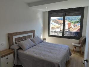 Ένα ή περισσότερα κρεβάτια σε δωμάτιο στο Apartamento en Moaña Rosalía de Castro
