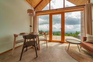 a living room with a table and a large window at Glamping Zarja, Vipava Valley in Zoll