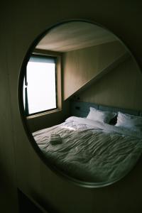 a bedroom with a bed with a round mirror at Tysha in Tatariv