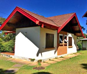 a small house with a red roof at Villa Rural in Campos do Jordão