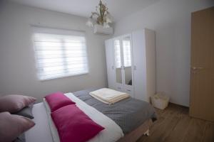 a bedroom with a bed and a cabinet with windows at Villa Sveta Obitelj in Međugorje